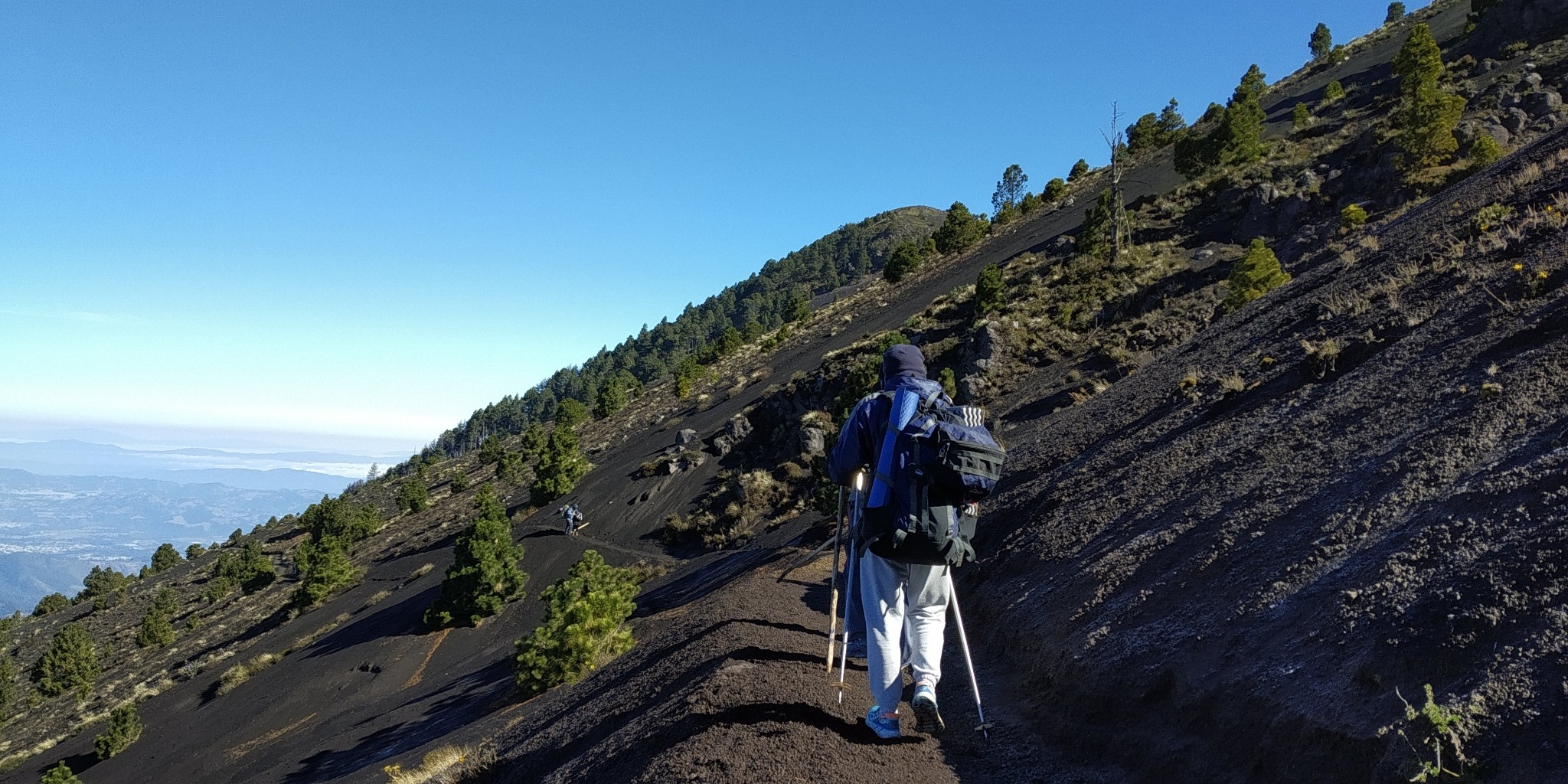 Hiker ascending a rocky mountain trail