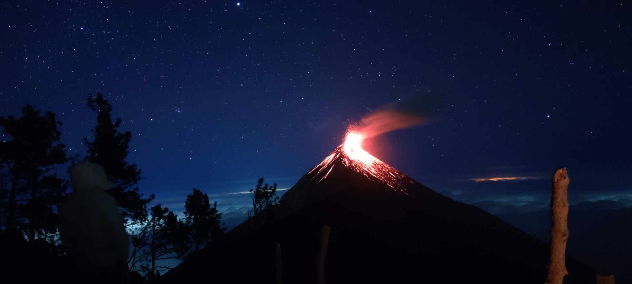 Glowing volcanic activity on Fuego beneath a starry sky