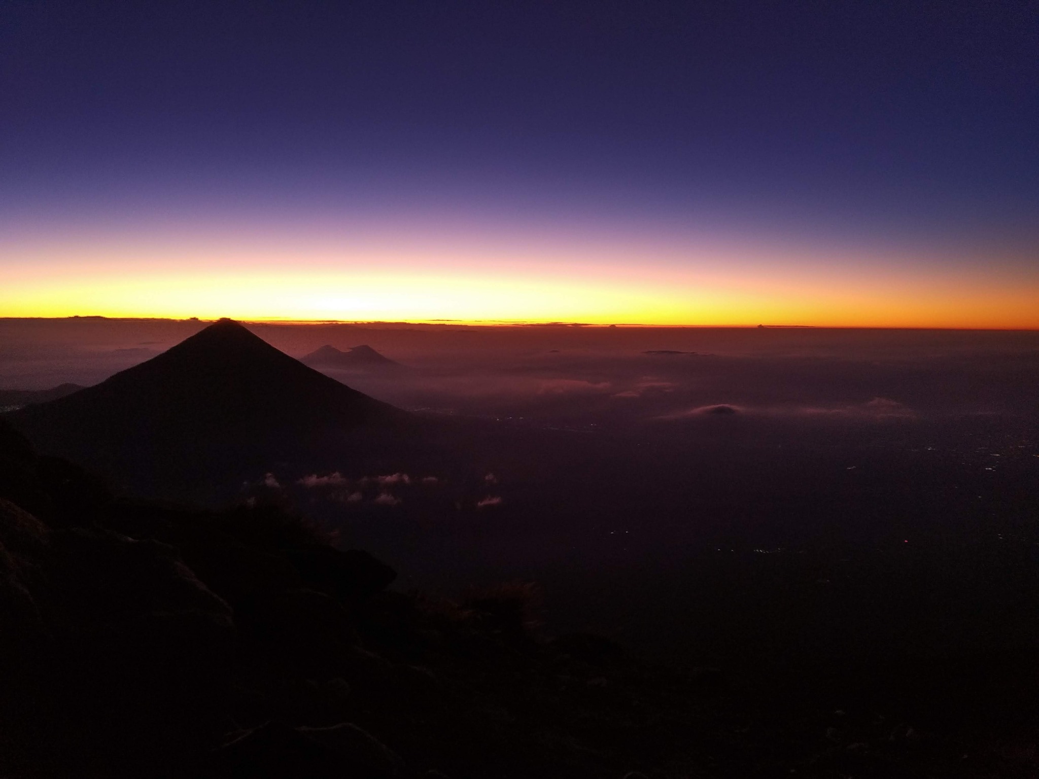 Volcanic silhouette beneath a glowing twilight sky